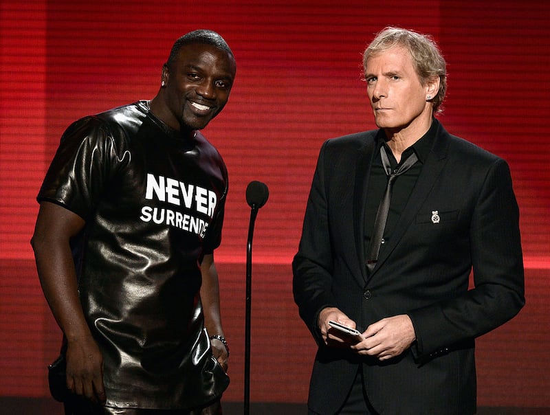 LOS ANGELES, CA - NOVEMBER 24:  Singers Akon (L) and Michael Bolton speak onstage during the 2013 American Music Awards at Nokia Theatre L.A. Live on November 24, 2013 in Los Angeles, California.  (Photo by Kevin Winter/Getty Images)